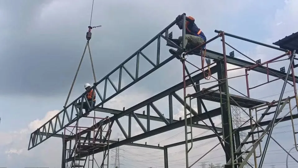 Steel roof truss installation work at height
